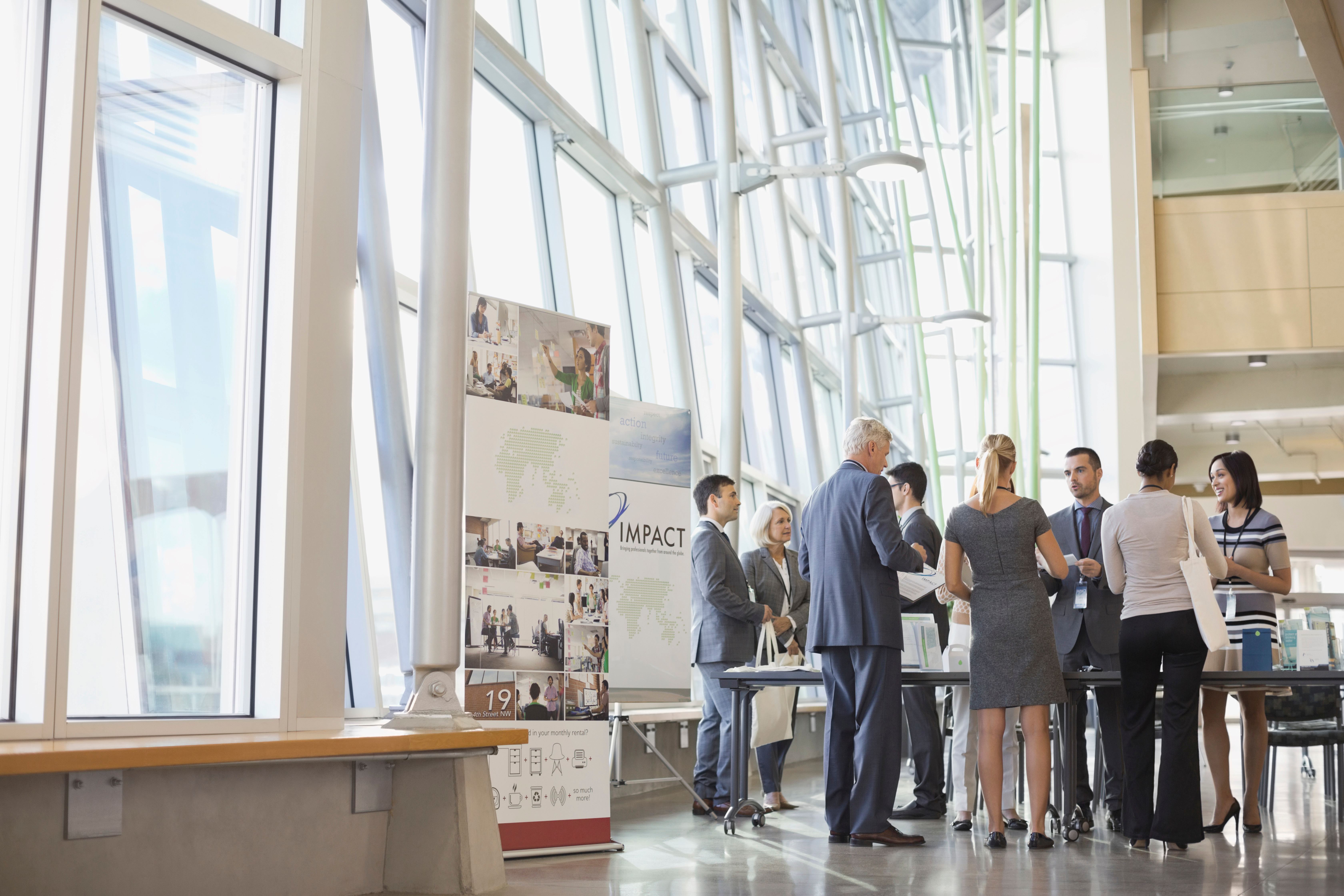 Group of professionals in business attire networking at an event