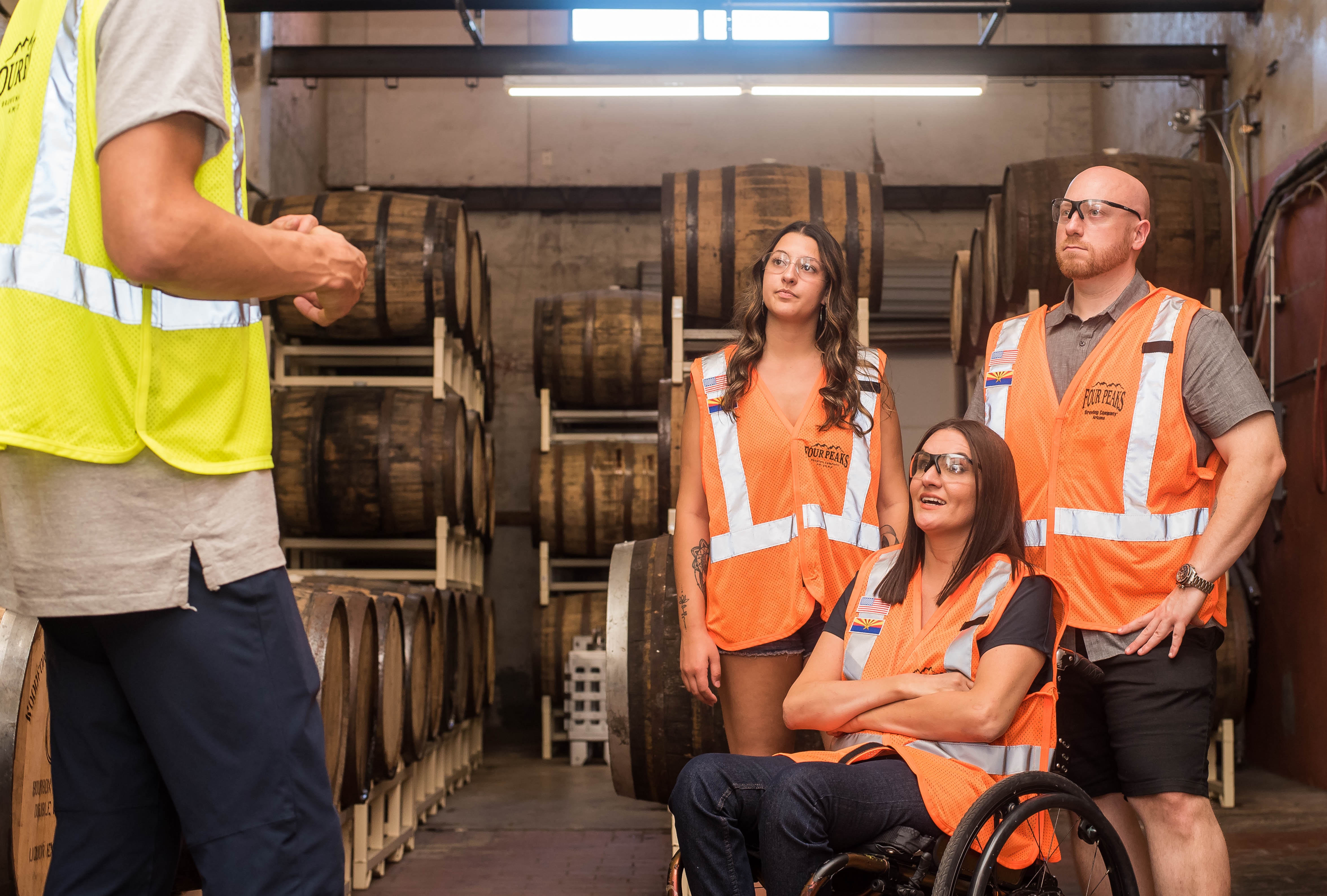 Group of individuals in a warehouse in reflective vests