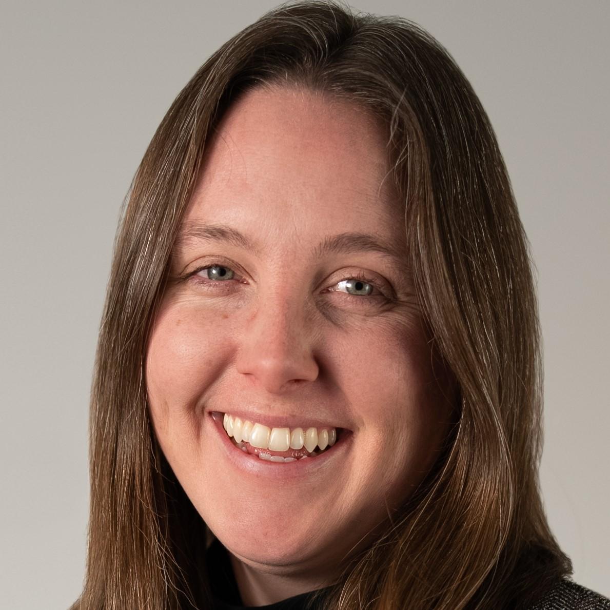 Bryn Nelson Headshot: woman smiling with long brown hair