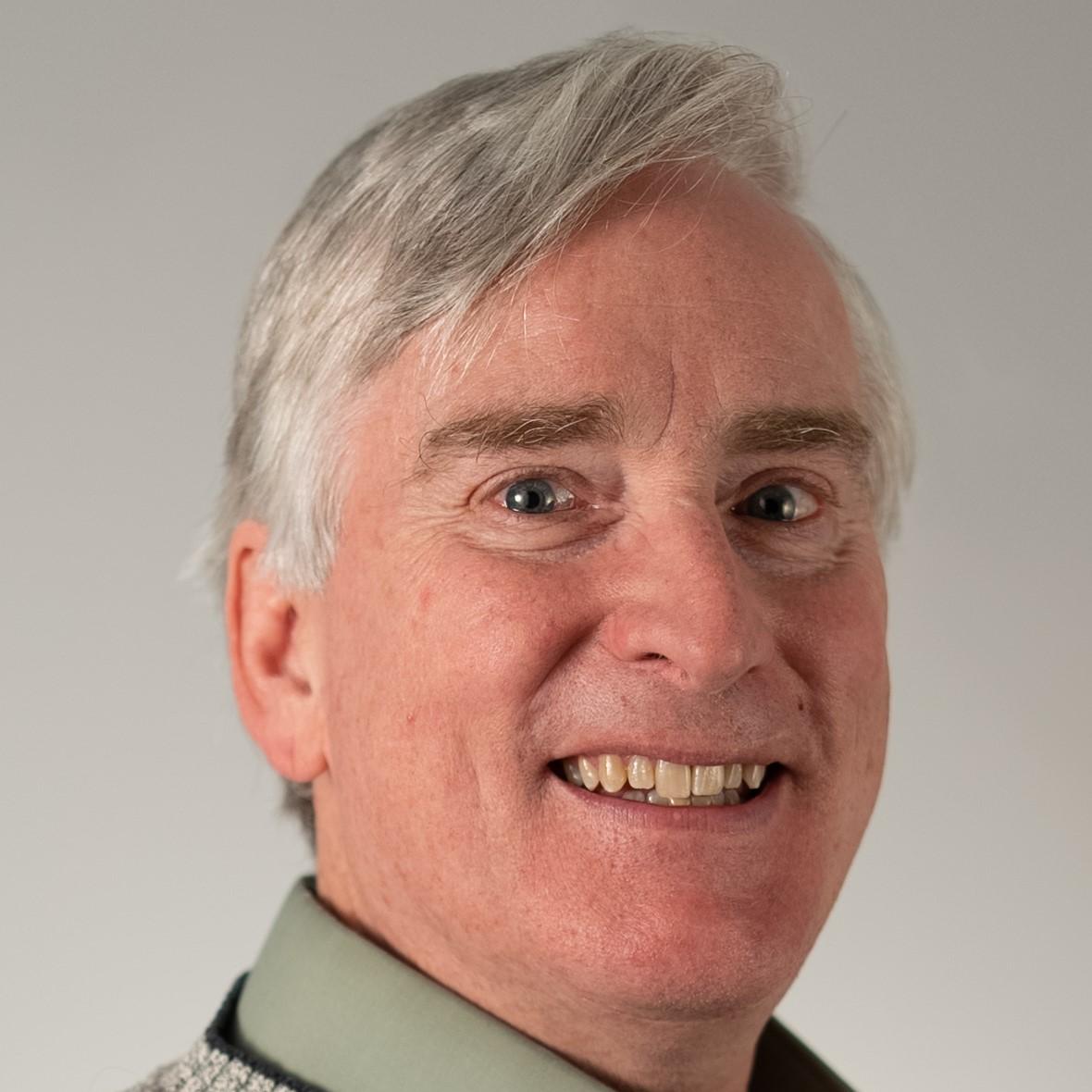 Dale Reed headshot: man with short gray hair and collared shirt