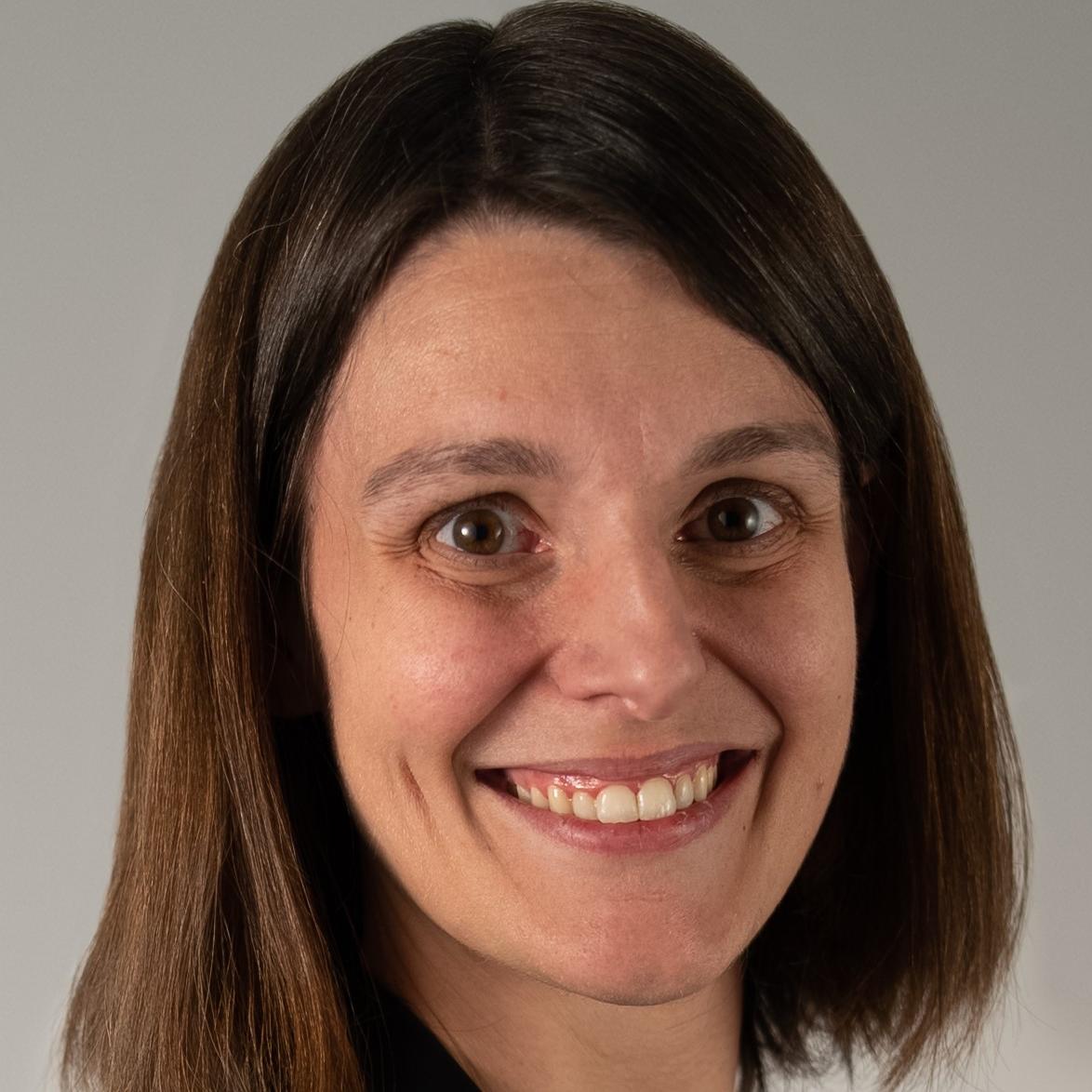 Denise Miller headshot: female with short brown hair and brown eyes