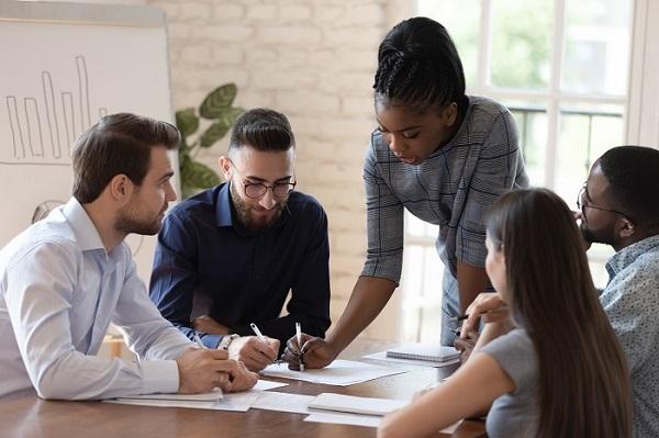 A female supervisor discussing a project with colleagues