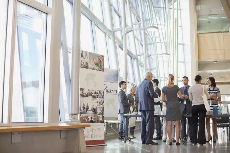 Group of professionals in business attire networking at an event